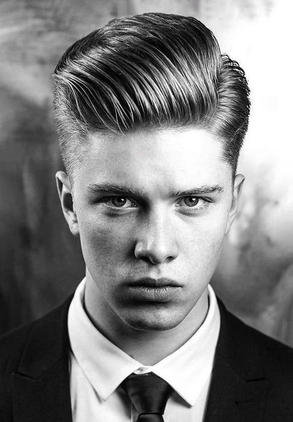 Man with a classic slicked side part haircut and faded sides