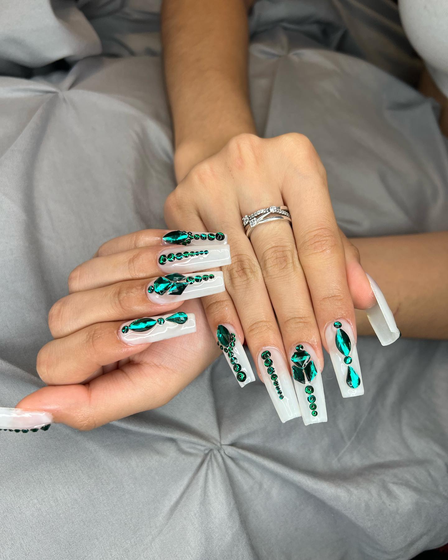 Long emerald green coffin nails with rhinestone accents