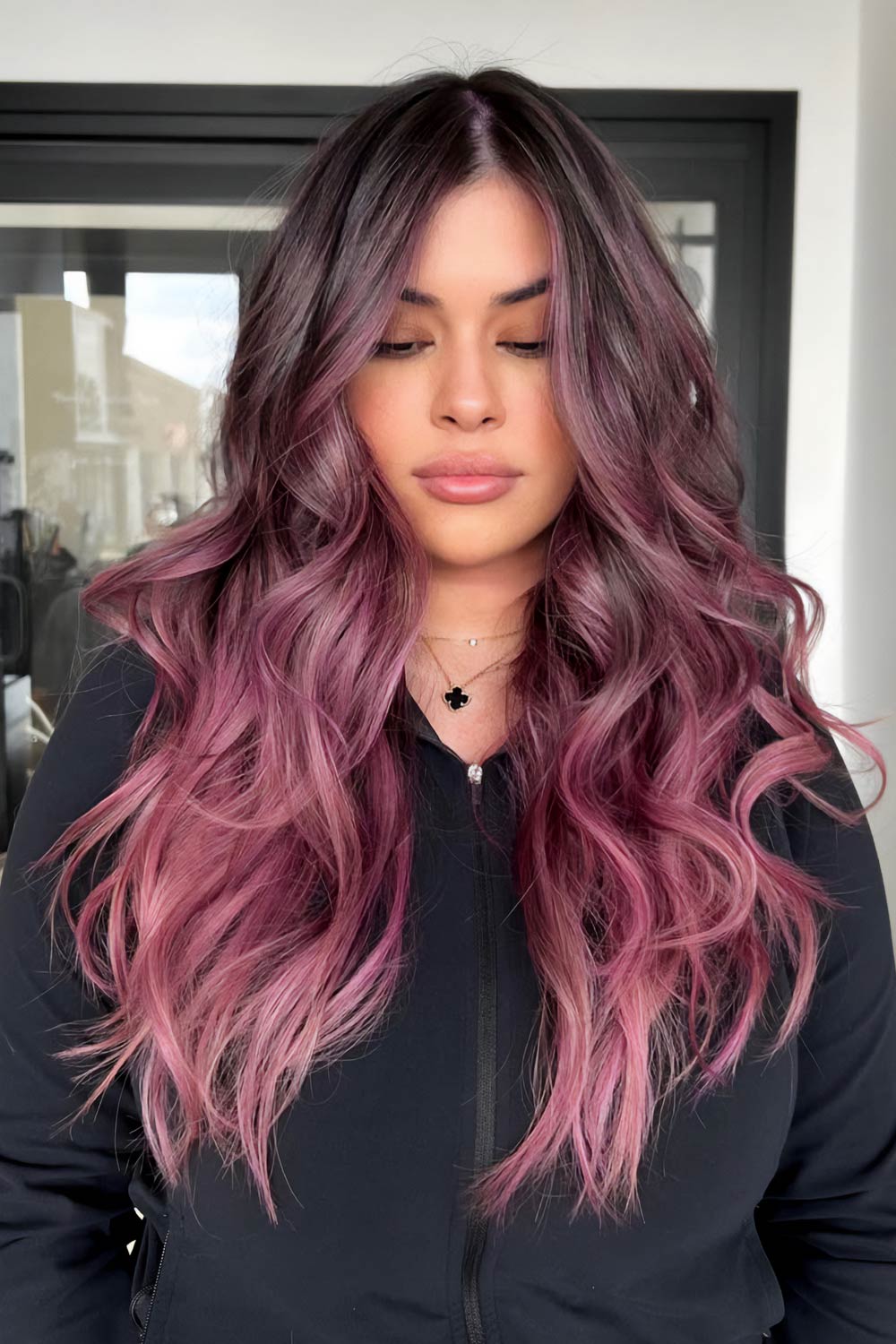 Front view of long wavy hair with dark roots melting into muted mauve pink-purple ends