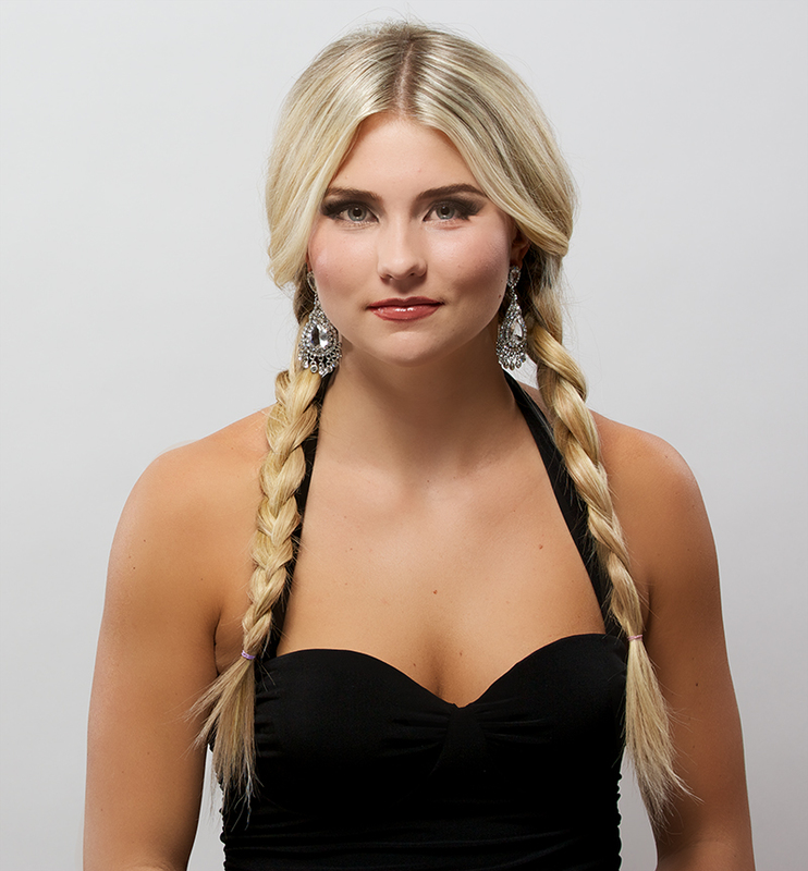 Strawberry blonde hair in loose milkmaid braids crossed over the crown