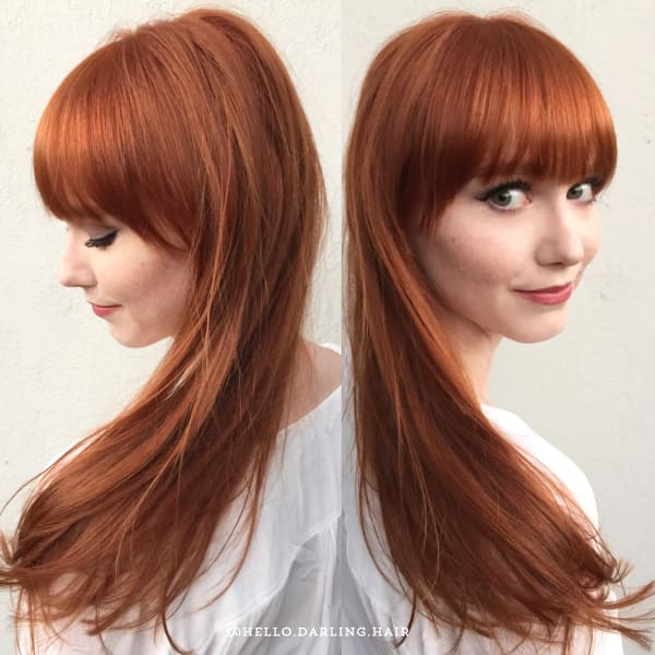 Copper penny hair color on a woman with glossy waves