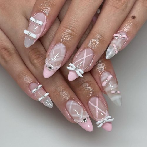 Sheer pink almond nails with tiny painted bows, plaid lines and micro-pearl dots