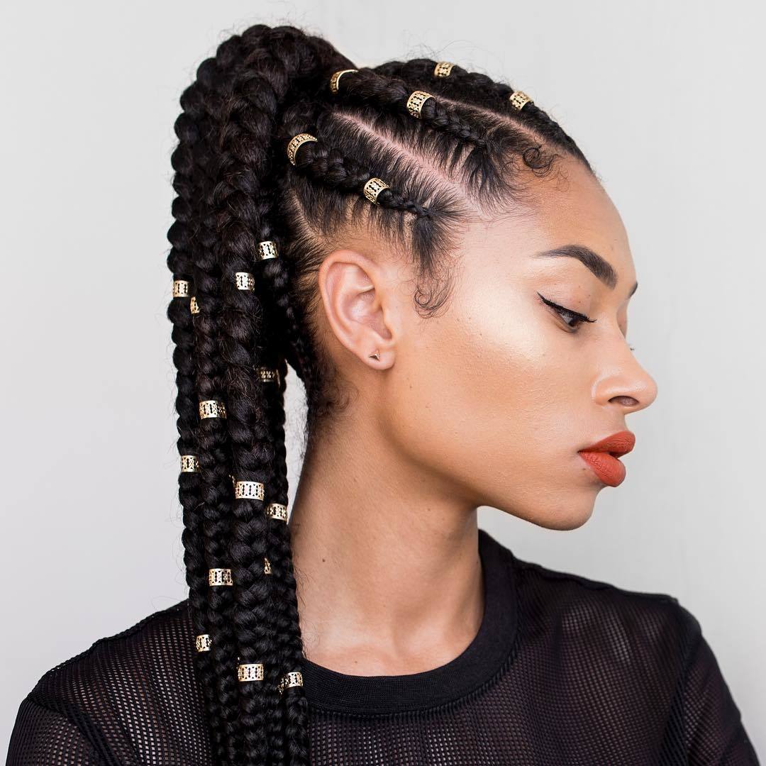 Black cornrow ponytail decorated with gold filigree hair cuffs