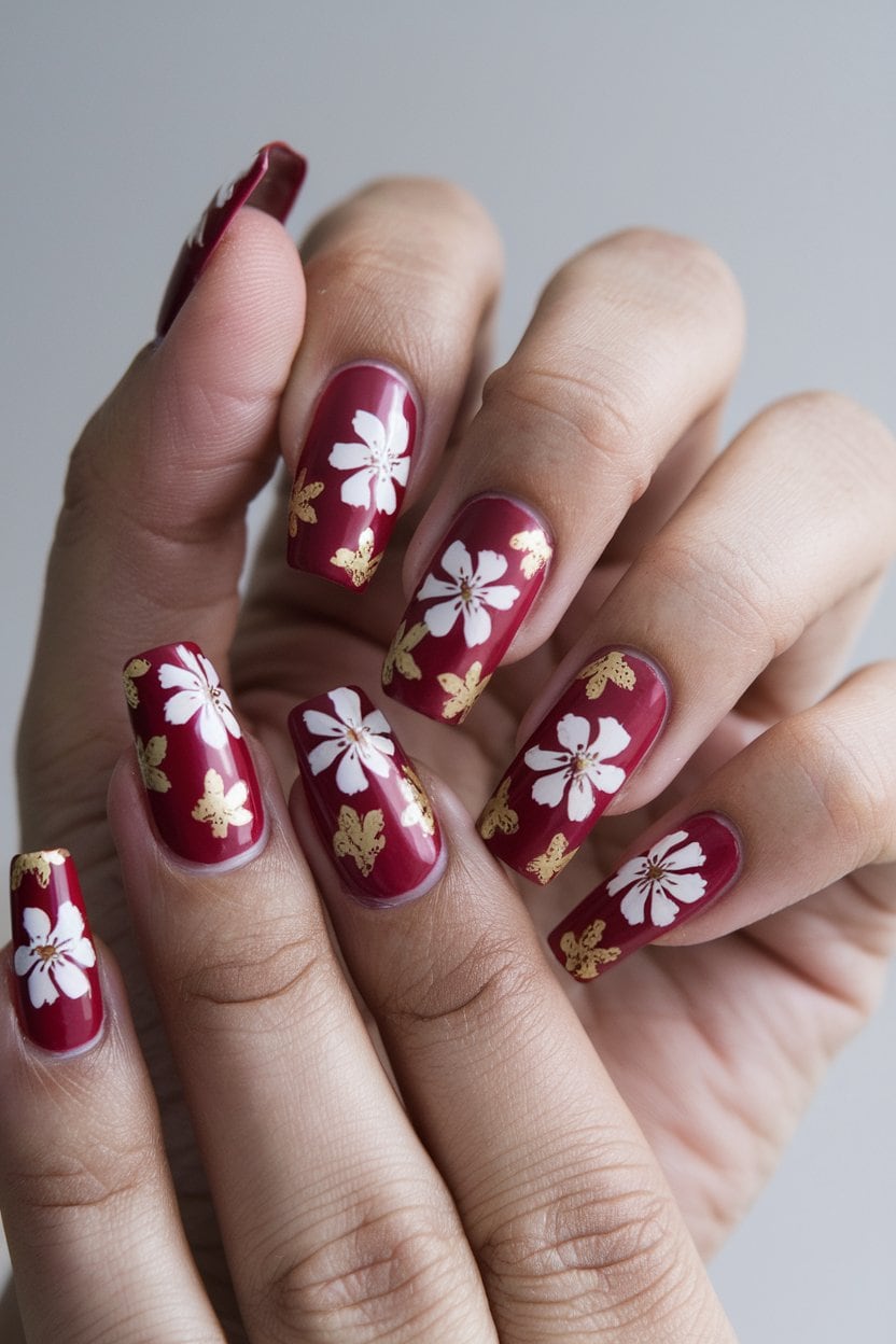 Cranberry red nails with gold foil accents