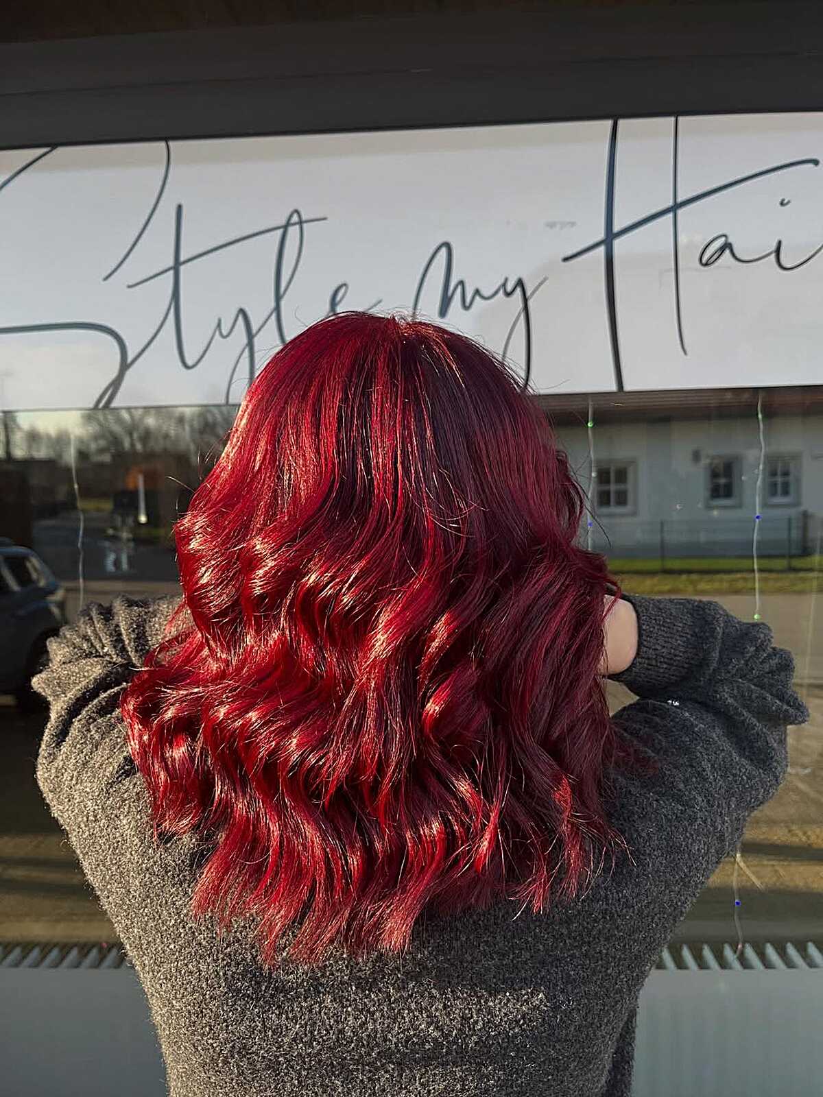 Long wavy hair in dark cranberry cherry red with high shine