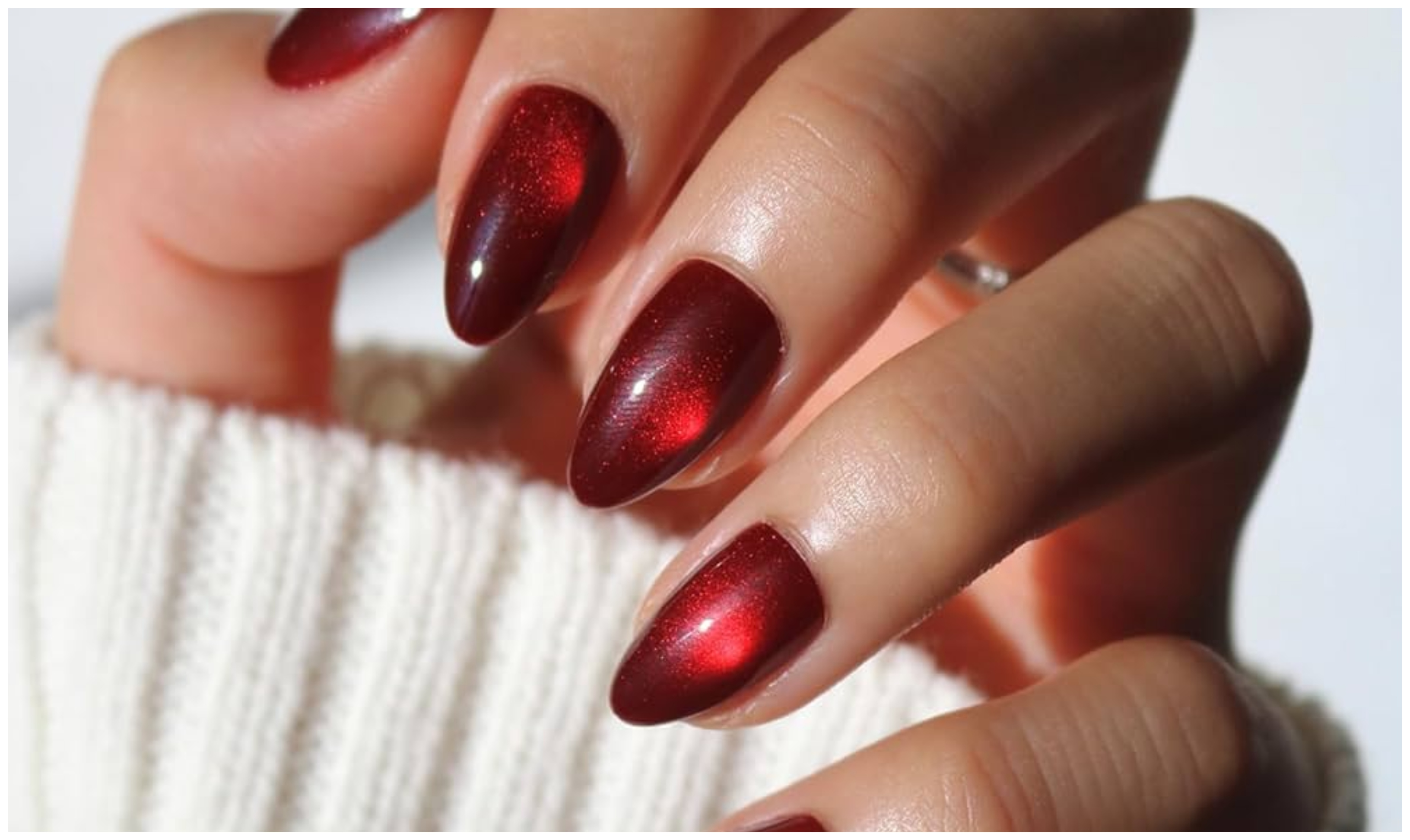 Cranberry red almond acrylic nails with a velvet cat-eye magnetic shimmer