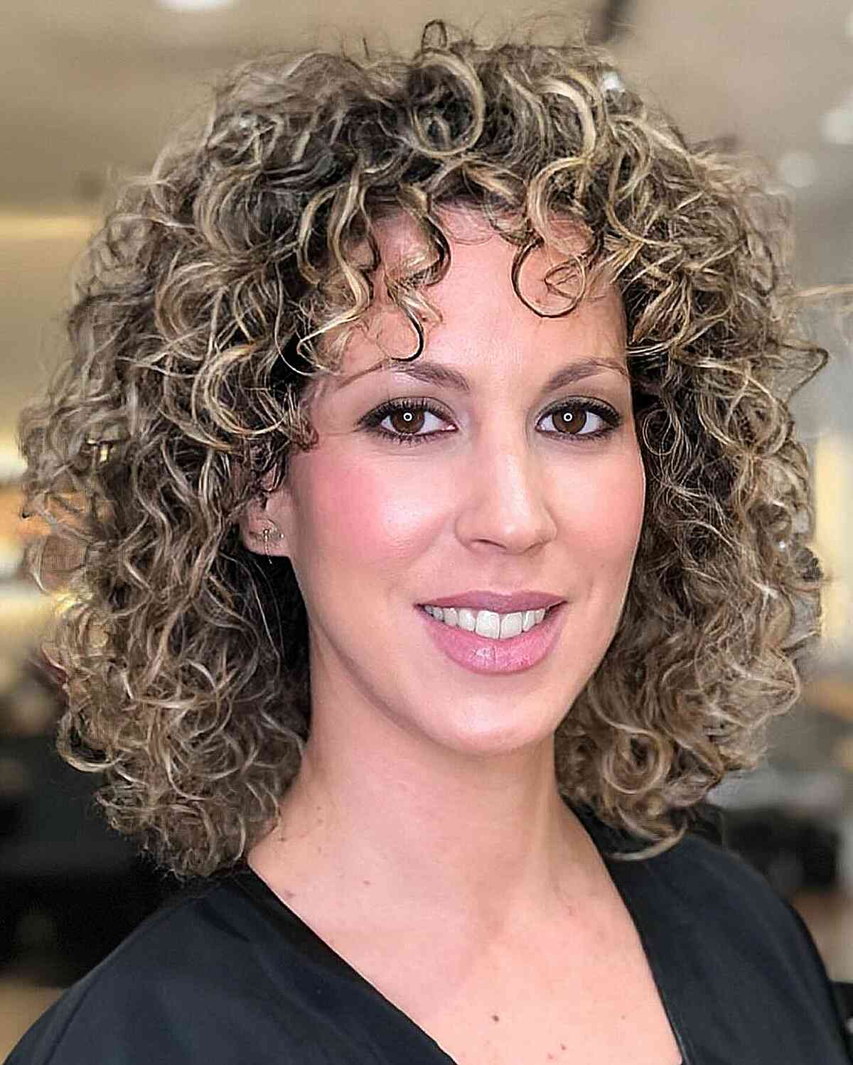 Curly lob with bangs and highlights on fine curls