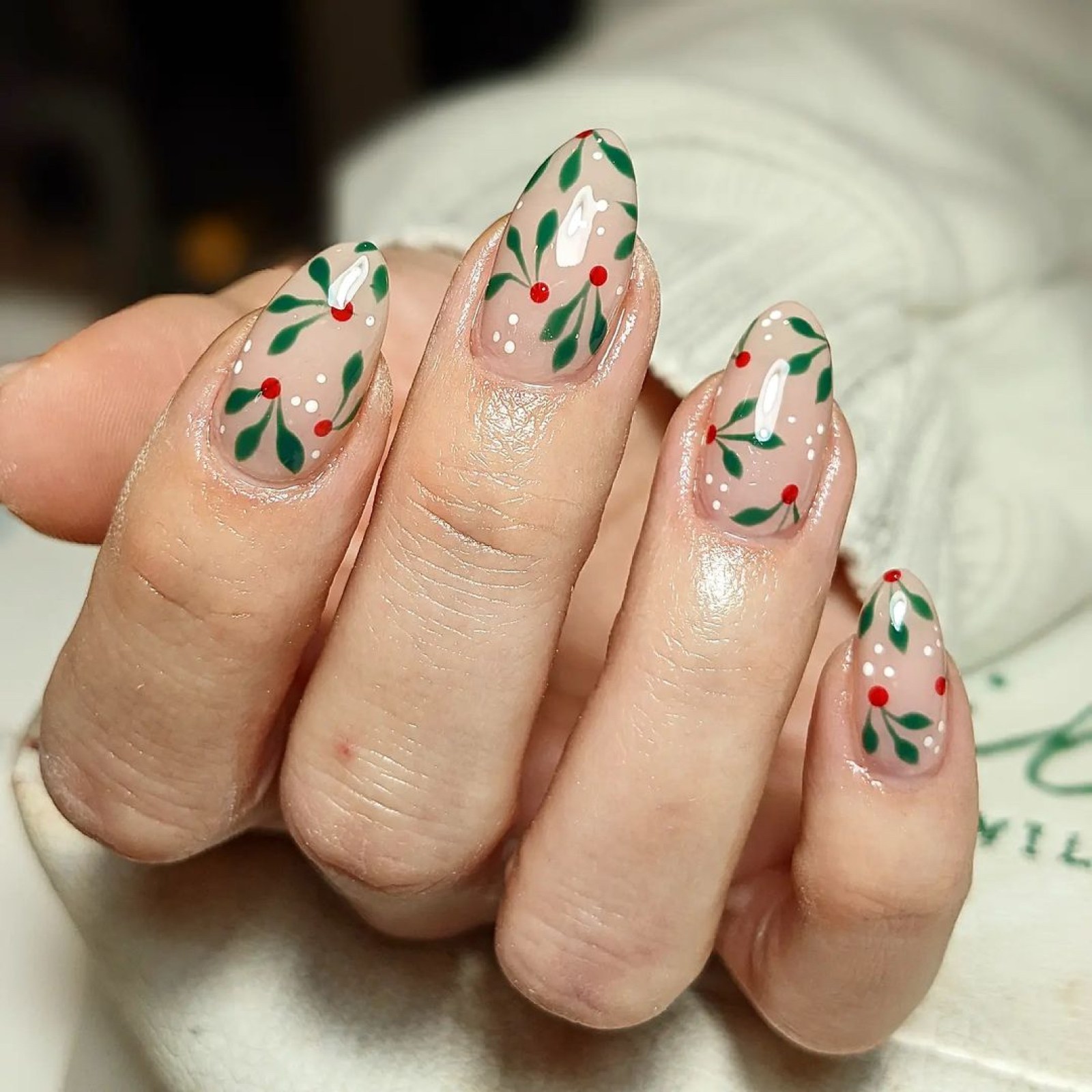Sheer nude nails with hand-painted holly berry sprigs
