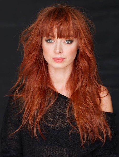 Long tousled copper red hair with full bangs, front view