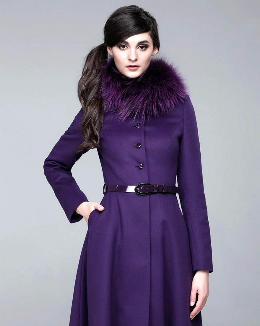 Woman in a violet fitted coat with fur collar and dark patent belt