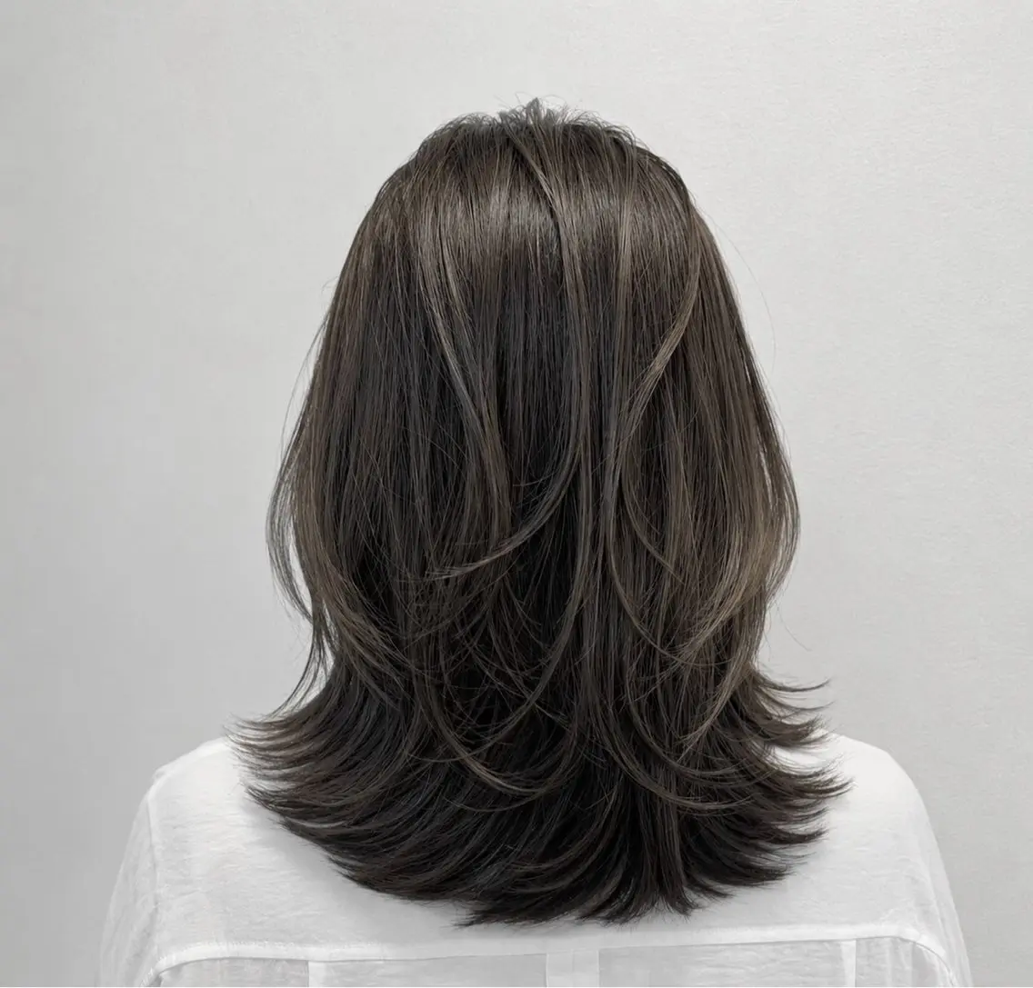 Medium length layered hair in dark ash brown