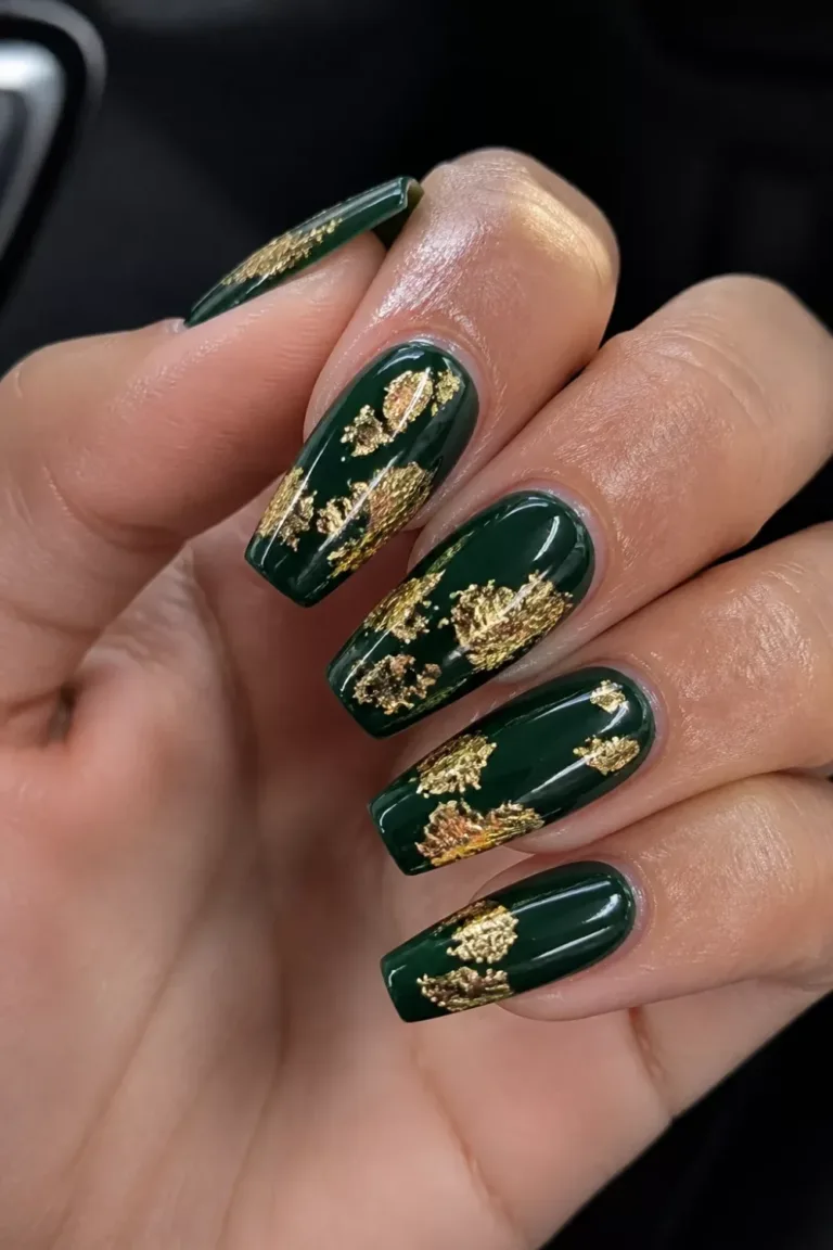 Long coffin nails in deep forest green gloss with scattered gold foil patches