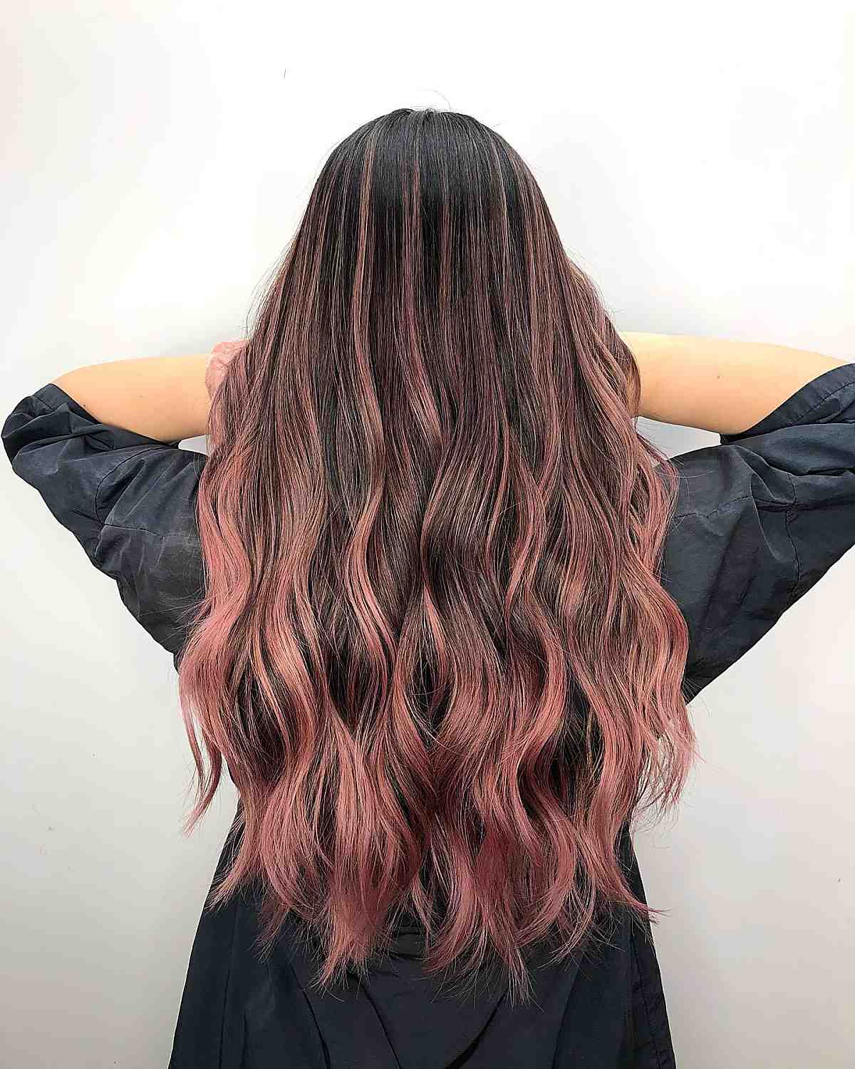 Dark brown hair with rose gold balayage undertones