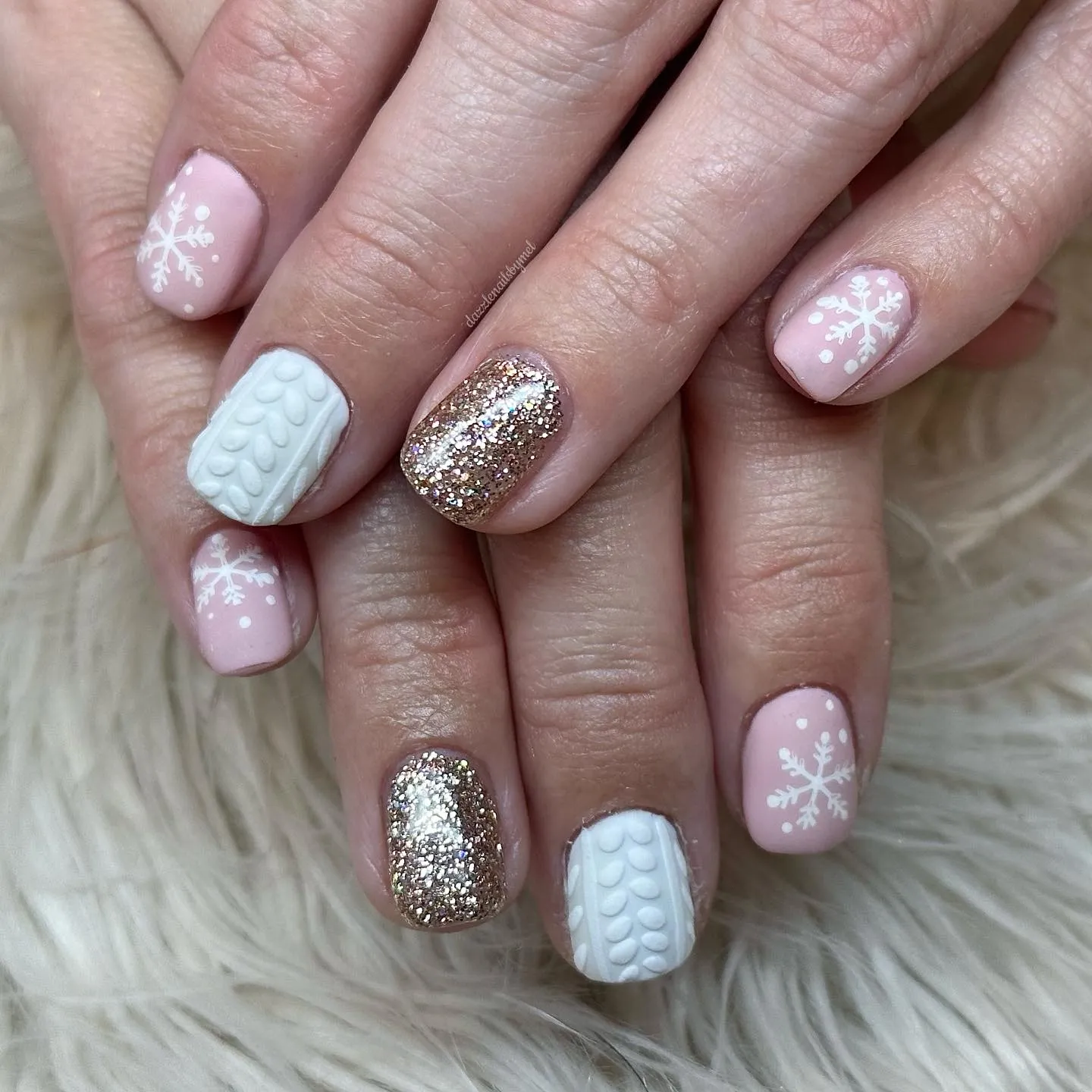 Short oval nails in blush pink with raised cable-knit sweater texture