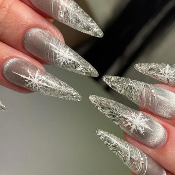 Frosted silver stiletto nails with white snowflake line art