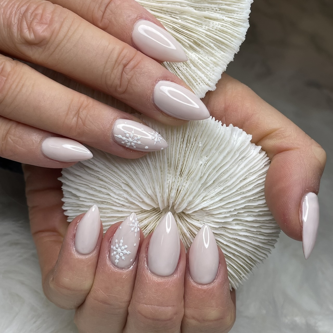 Nude nails with snowflake nail art