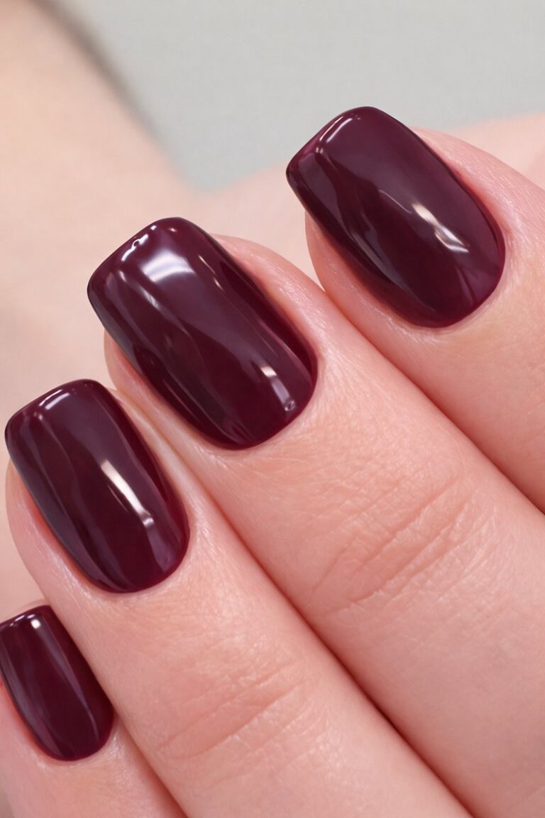 Short nails with deep aubergine plum gel polish