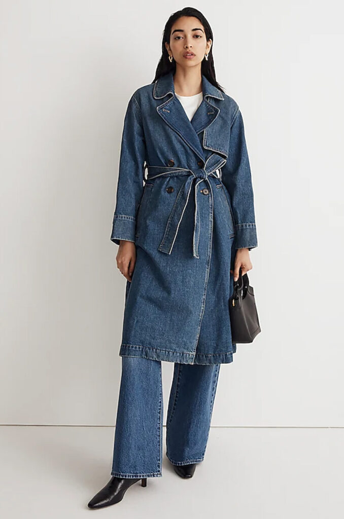 Woman in a denim trench coat, jeans and black pointed-toe ankle boots