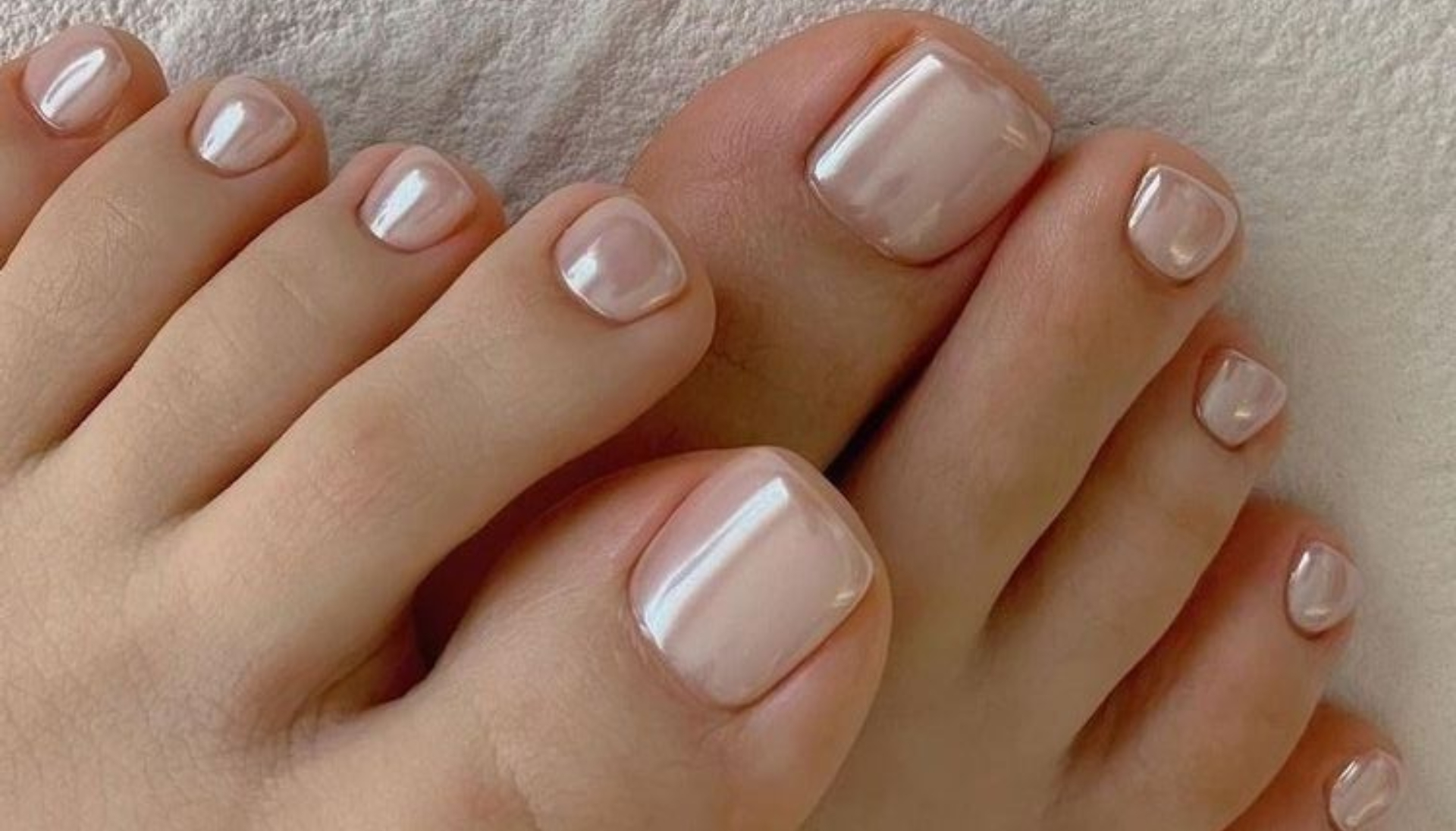 Pale pink chrome pedicure with a mirror-like glazed finish