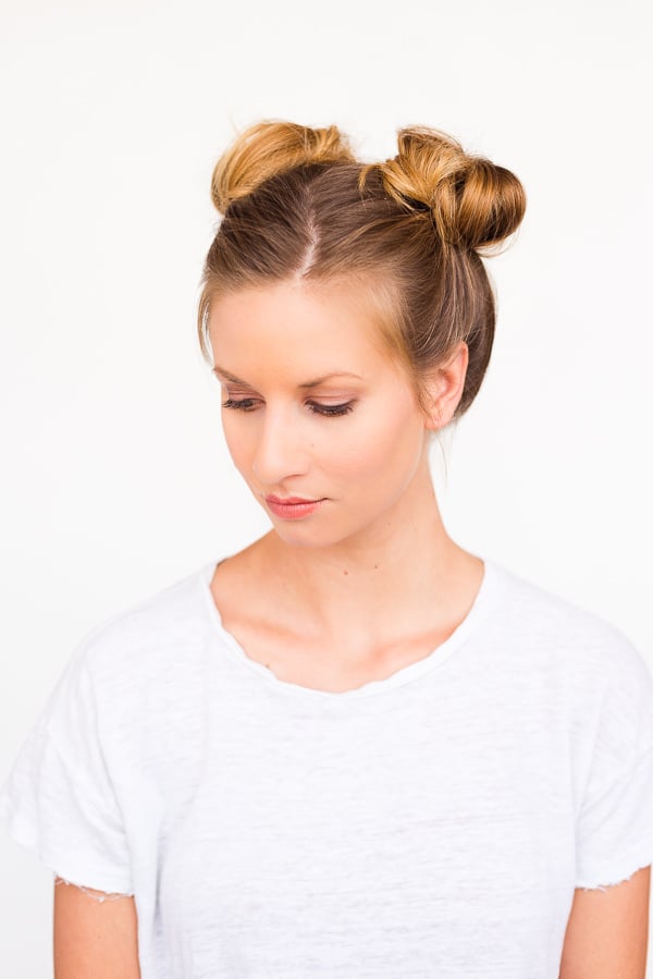 Front view of a woman wearing double mini buns