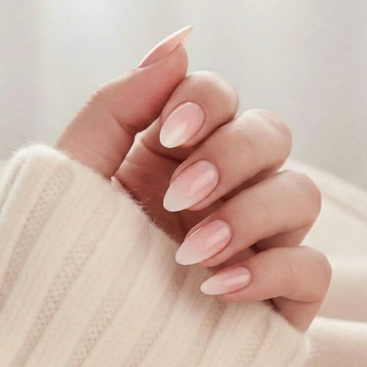 Almond nails with a baby boomer pink to white ombre gradient