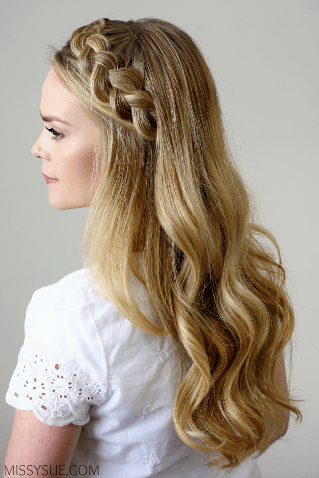 A dutch braid tracing the hairline like a headband with the rest worn loose