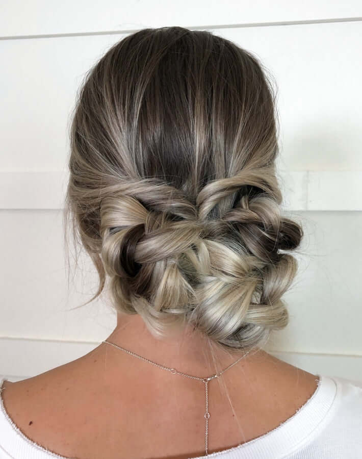 Low bun updo built from three pancaked braids pinned together
