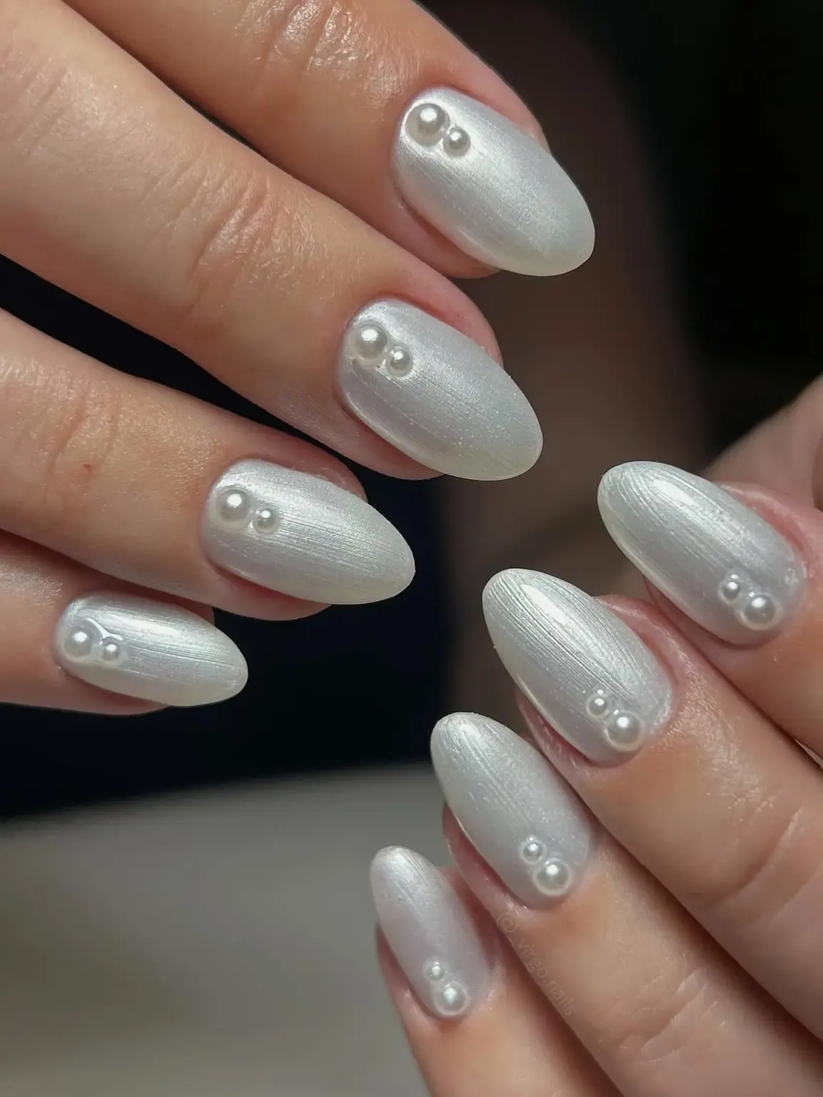 Porcelain white nails with a single pearl accent