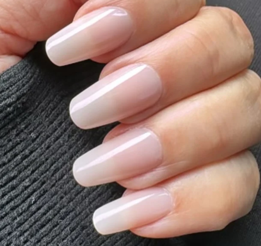Coffin nails in milky sheer nude polish with glossy finish