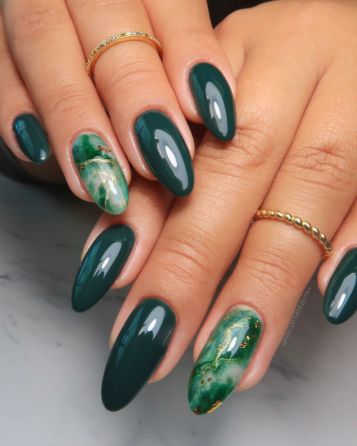 Emerald green nails with gold foil flake accents
