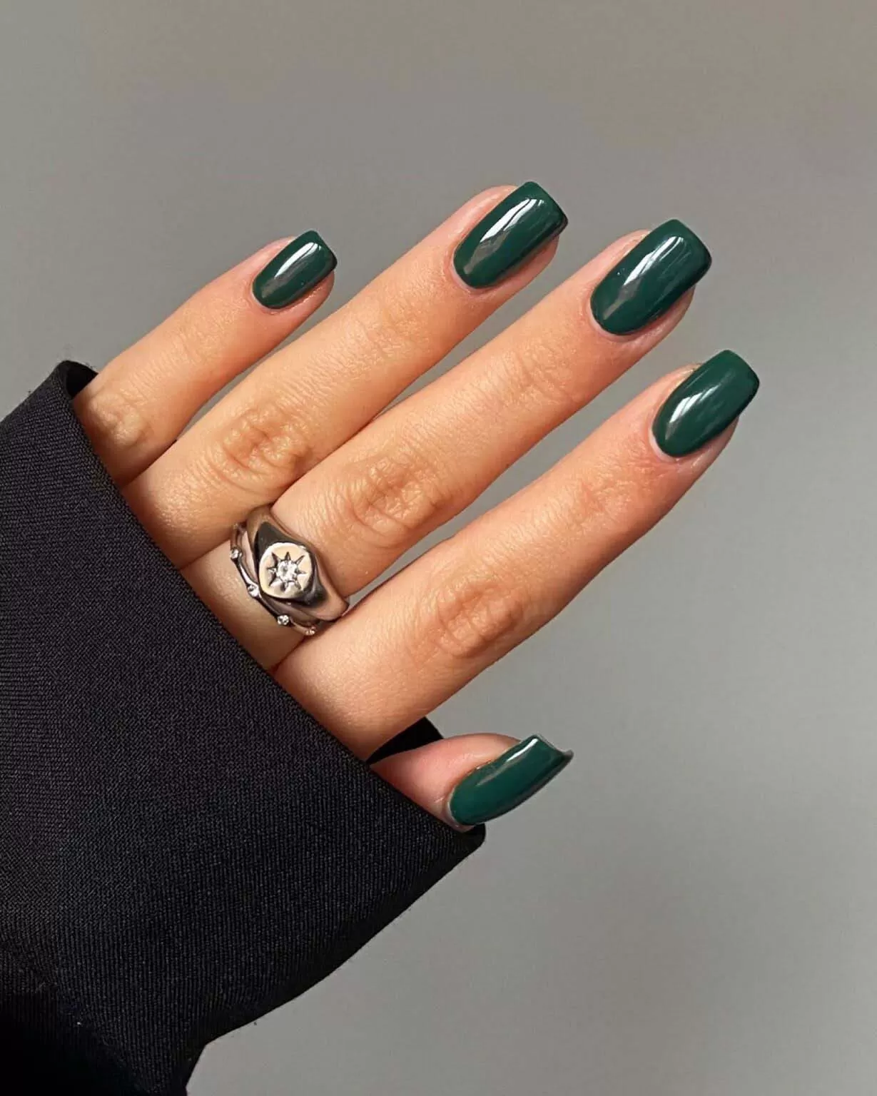 Short oval nails in glossy forest green polish