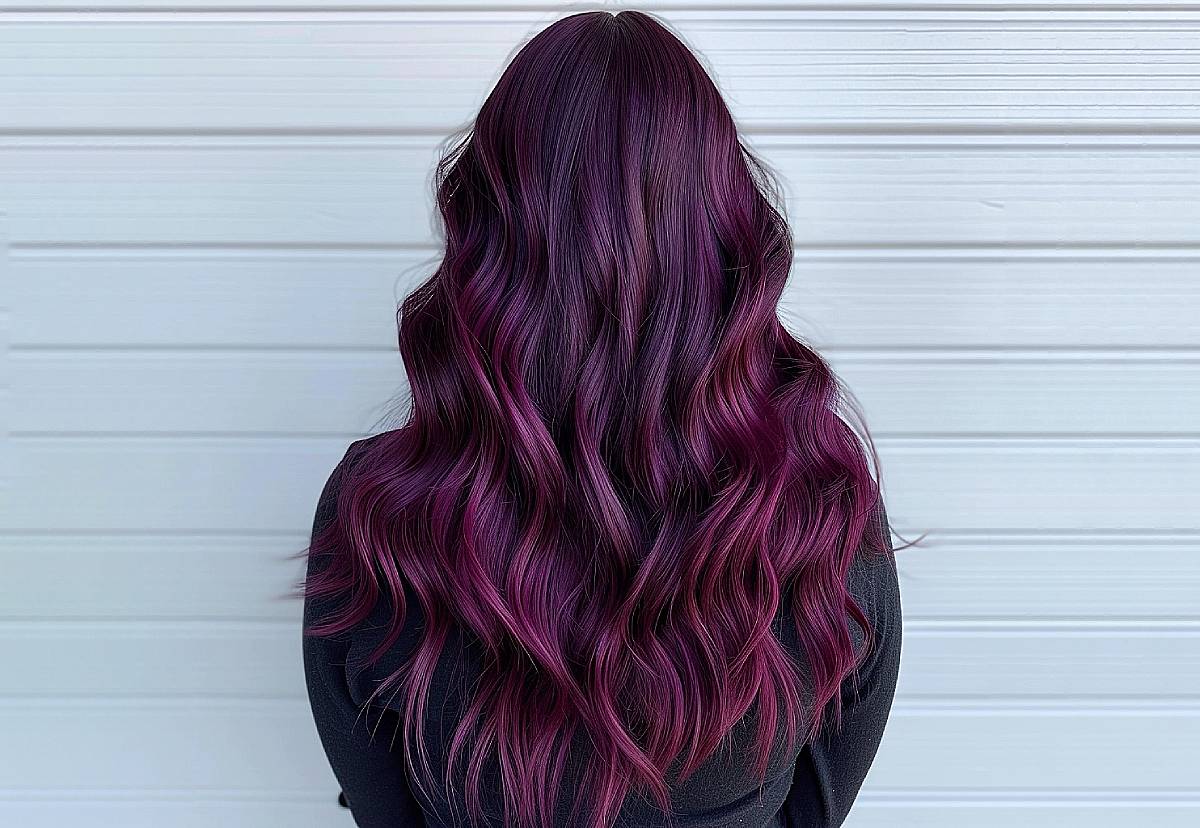 Dark curly hair with deep plum violet undertones