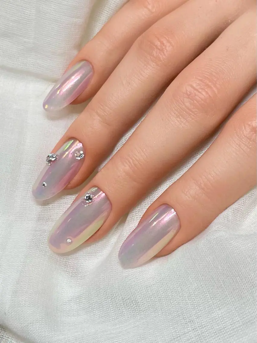 Aurora chrome nails with iridescent shimmer and rhinestone accents