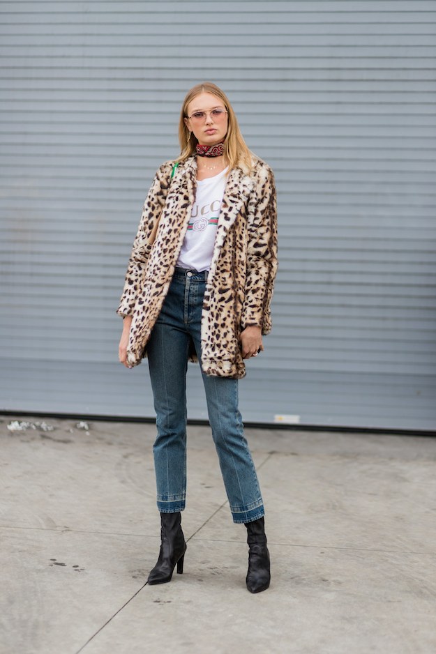 Leopard faux fur jacket with white graphic tee, dark jeans and black heeled ankle boots