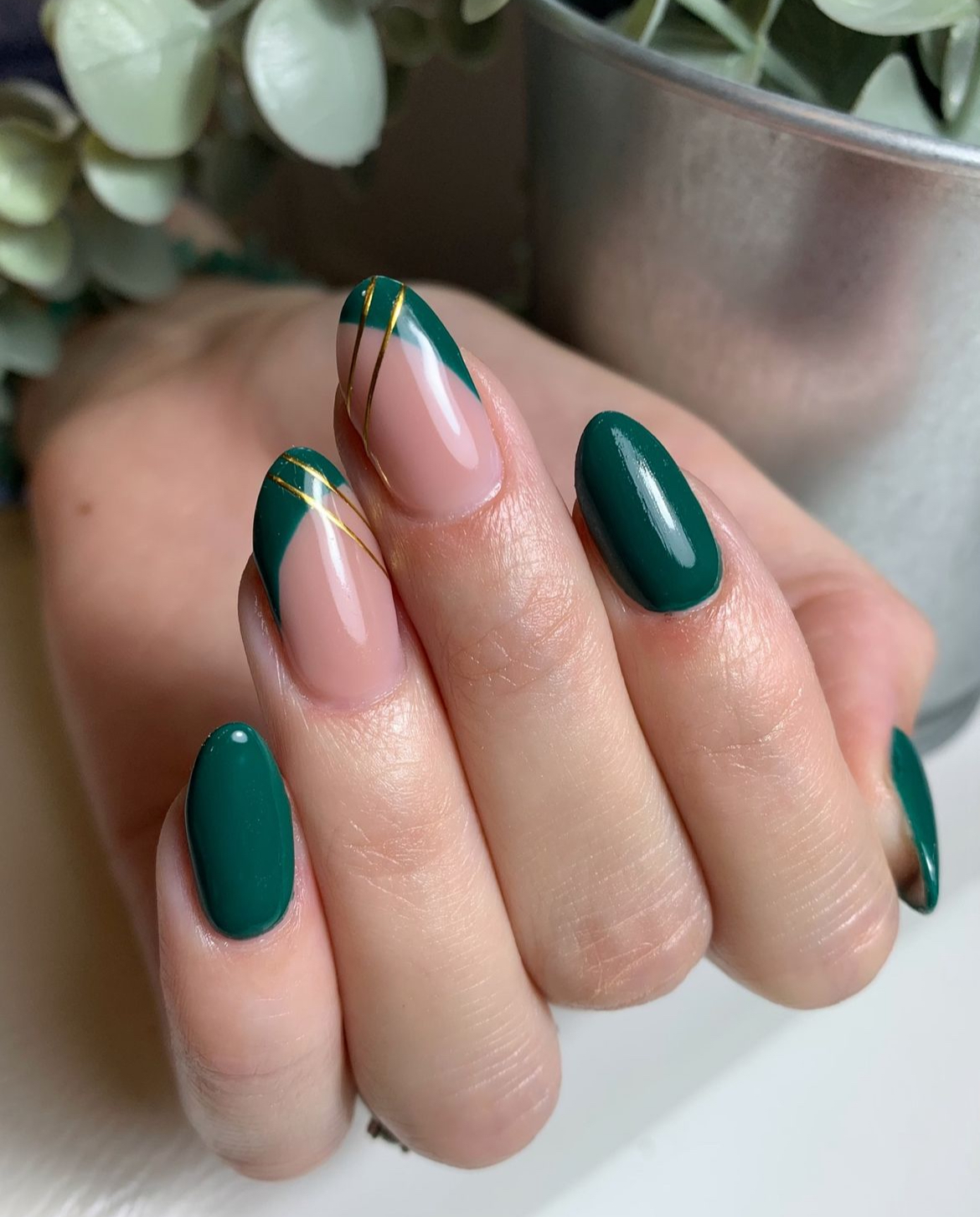 Forest green almond nails with nude accents and gold line art