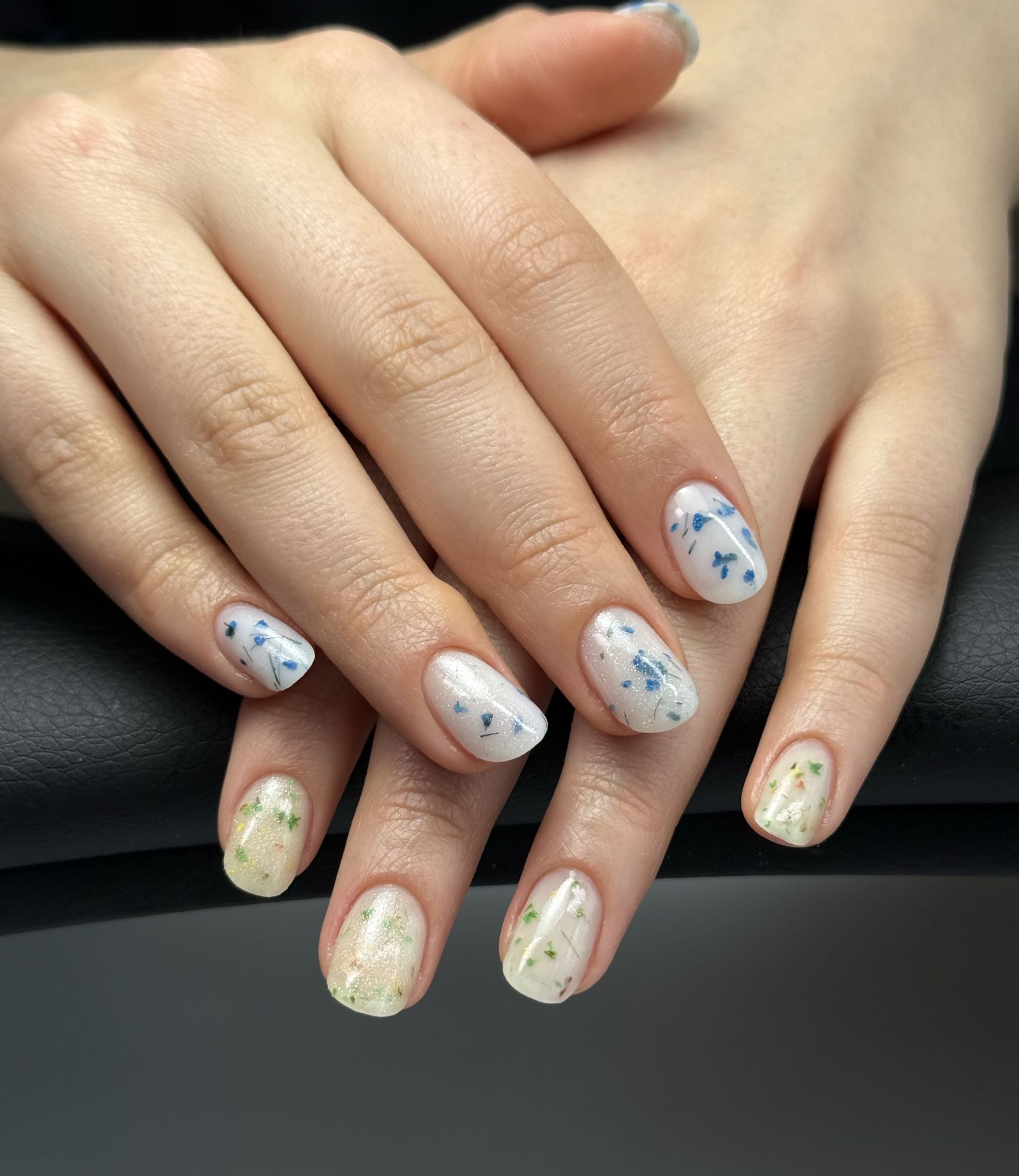 Milky white nails with a dried-flower accent nail