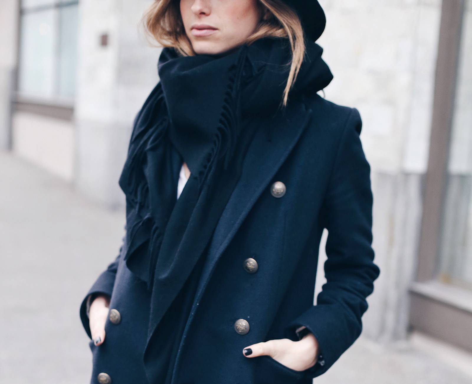 Woman wearing a navy coat in a winter outfit