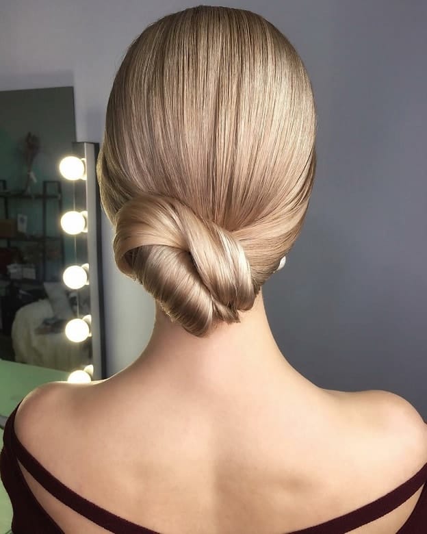 Sleek low French twist with polished finish, back view