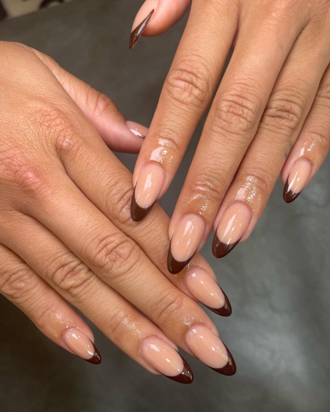 Chocolate brown French tips on glossy nude nails