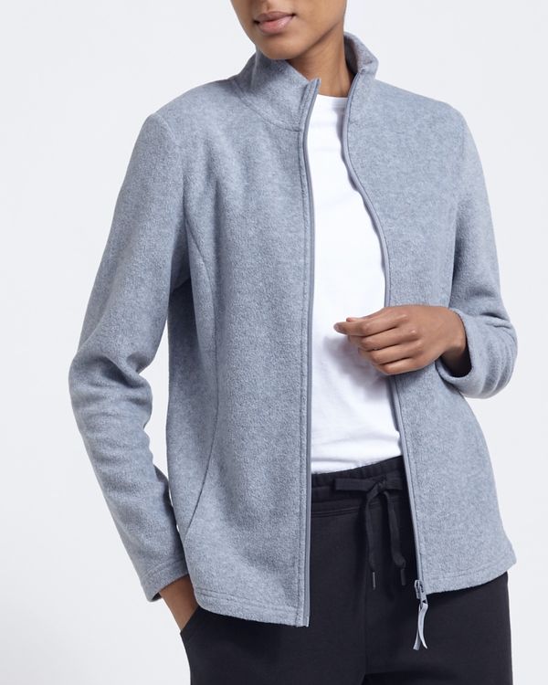 Woman in a grey fleece zip-up over a white tee with black joggers