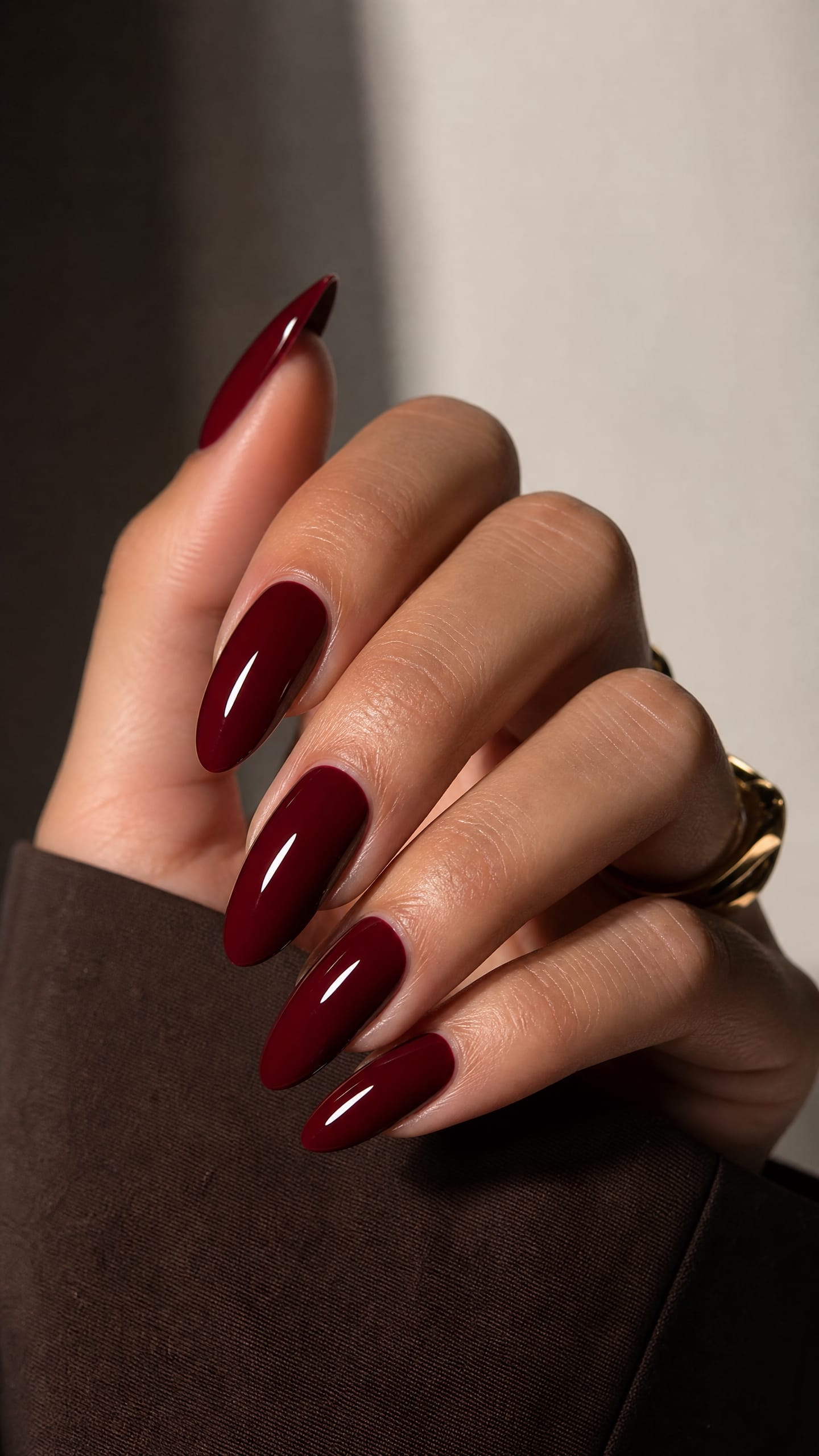 Deep cherry red glossy nails, long almond