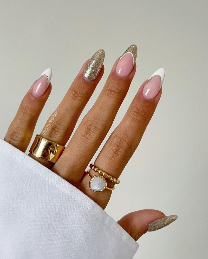 White french tip nails with a second thin gold glitter smile line