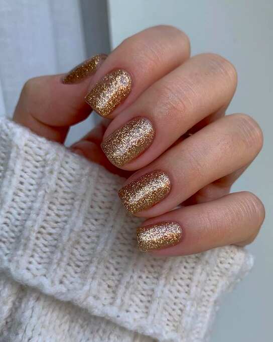Sheer nude gel nails with thin gold French tips for New Year's Eve