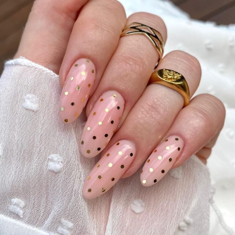 Sheer pink nails with tiny gold dot accents