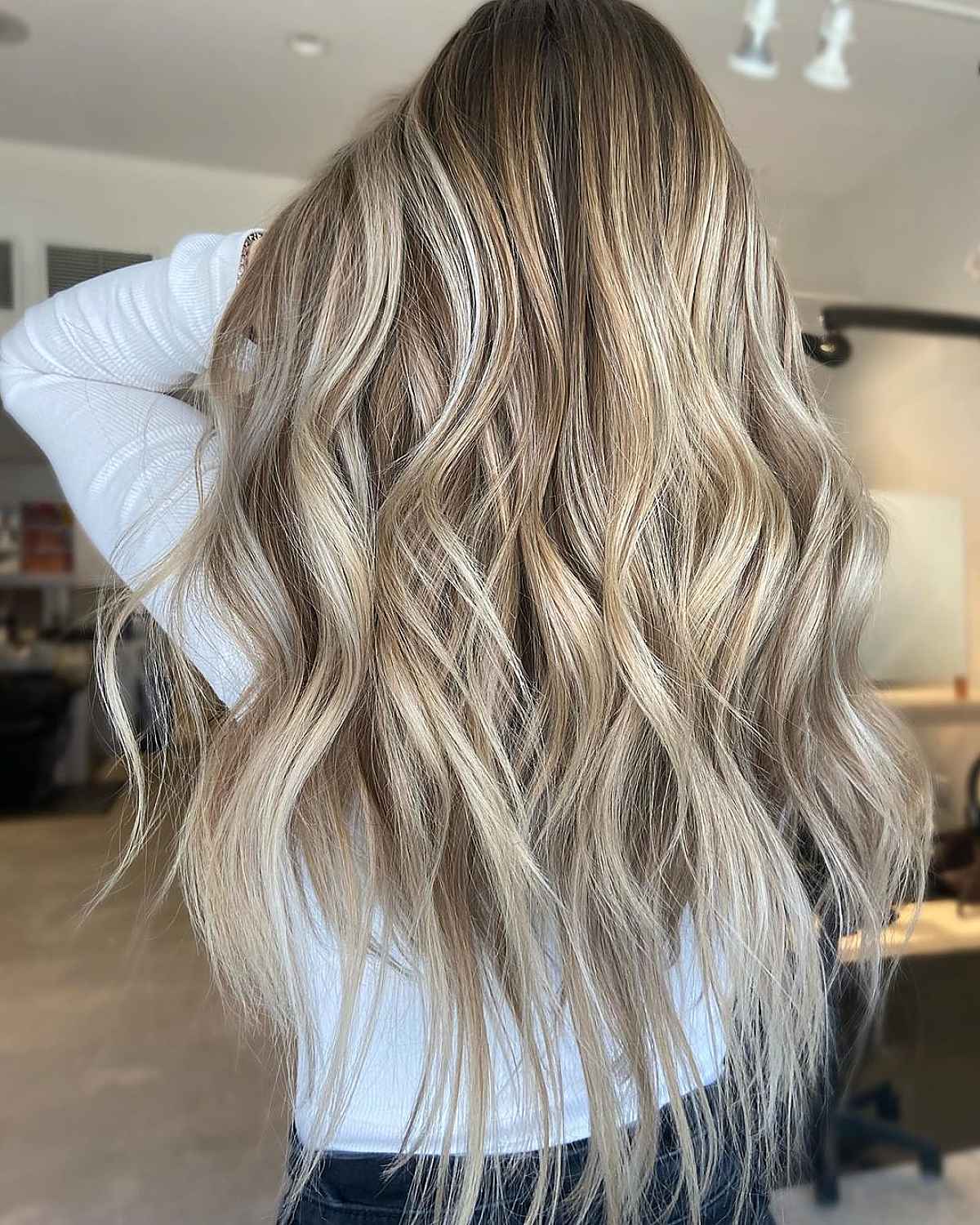 Dirty blonde hair with a blurred root and tousled texture