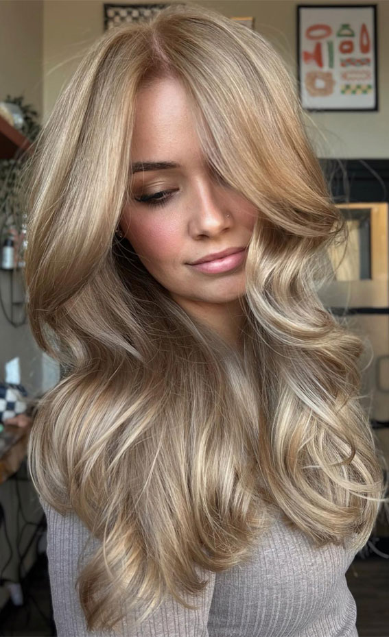 Front view of long wavy hair with warm dark roots melting into champagne-blonde ends