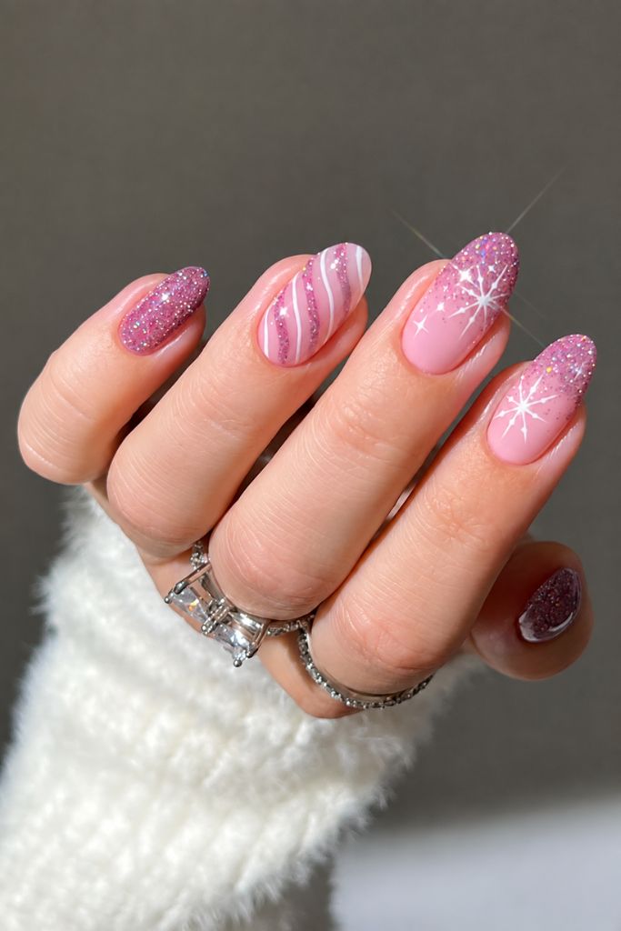 Pink glitter nails with swirl and snowflake holiday nail art
