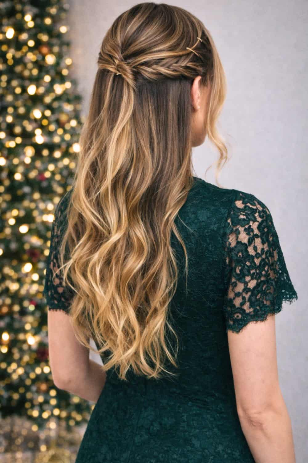 Side-swept loose braid over one shoulder with beachy waves and small gold pins