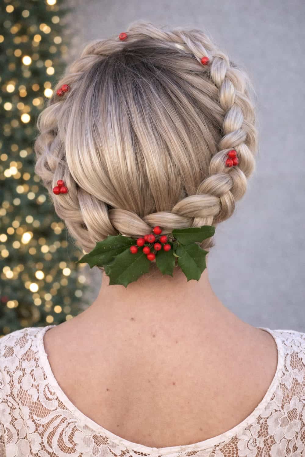 Dutch braid crown wrapping around the head with tiny red berry pins woven through
