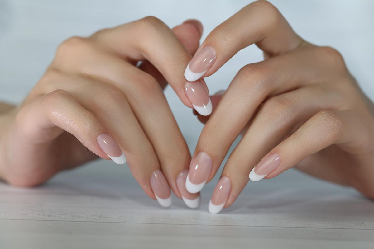 Classic French manicure with crisp white tips on a pink base